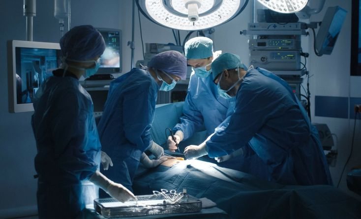 Surgeons and nurses providing care during a procedure